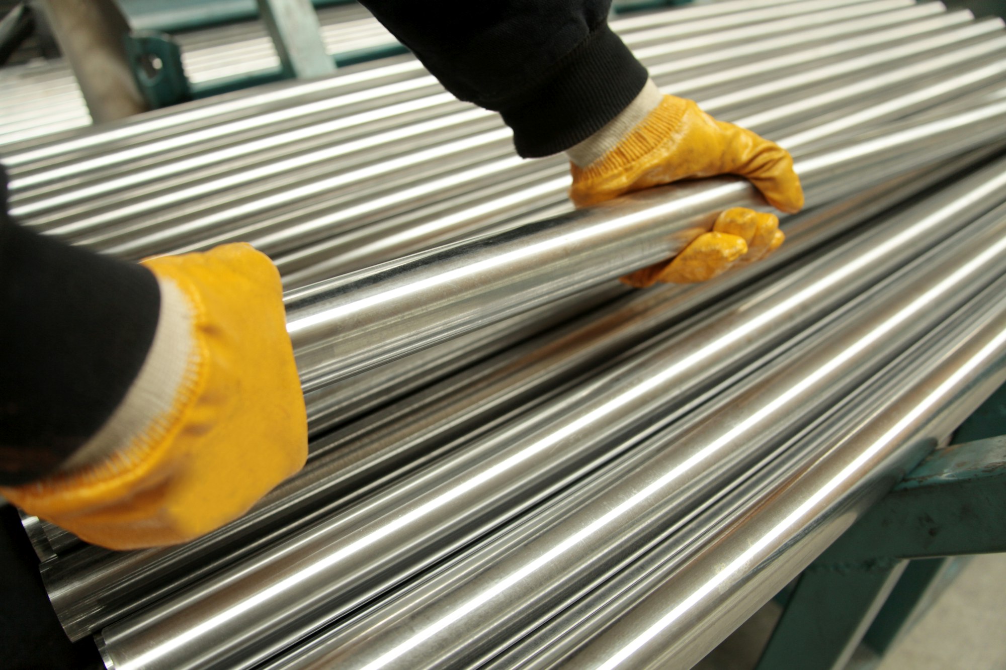 New steel pipes. A worker at the factory.